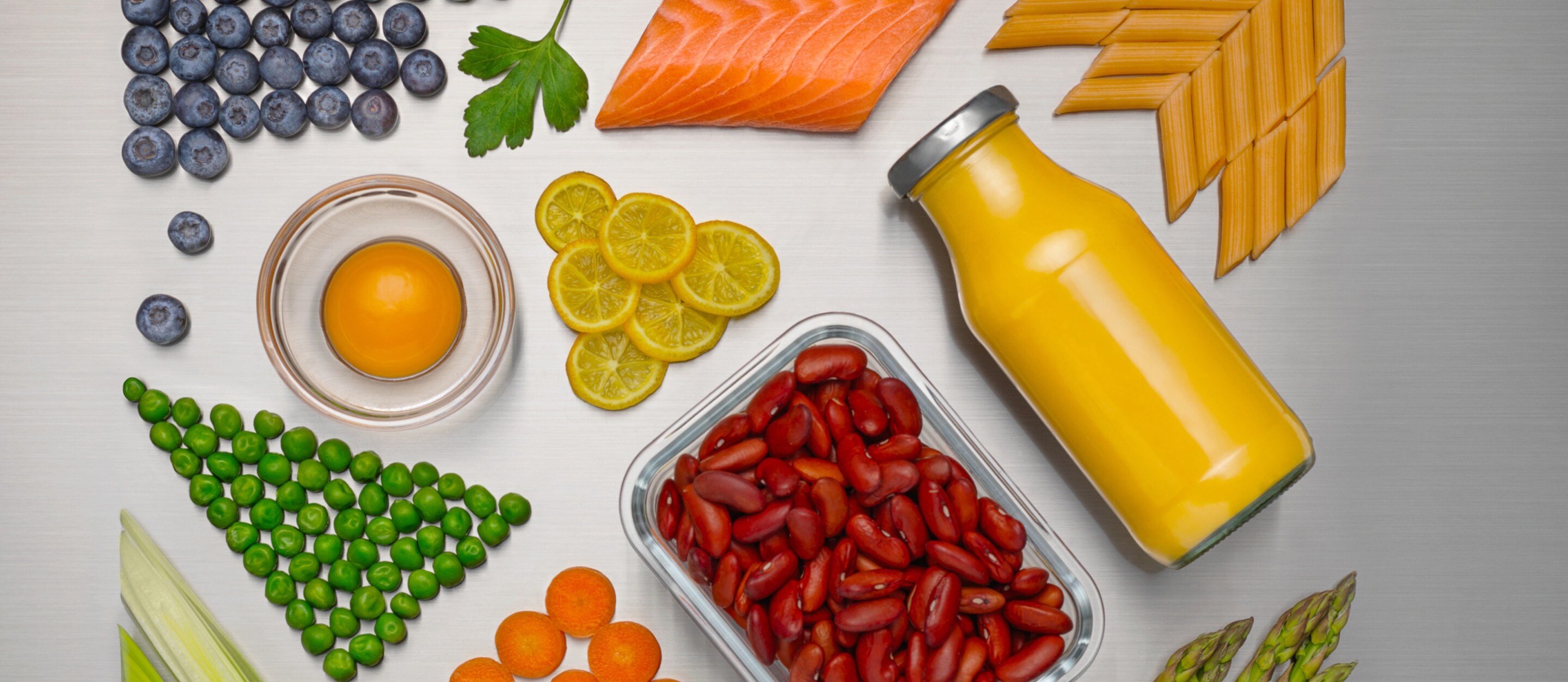 Different fresh food and drinks displayed on a silver background