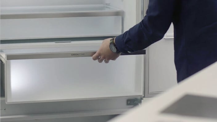 Opens fridge drawer