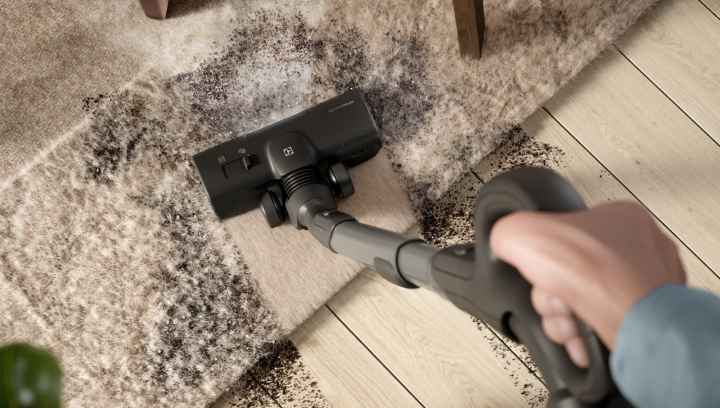 Vacuum cleaner cleaning dirty carpet and floor.