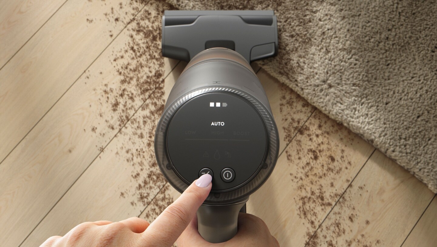 View from top of a vacuum cleaner cleaning a dirty floor.