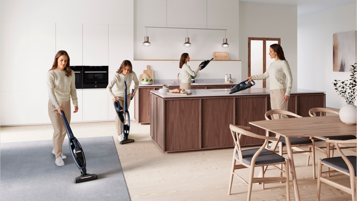 Woman vacuuming in kitchen
