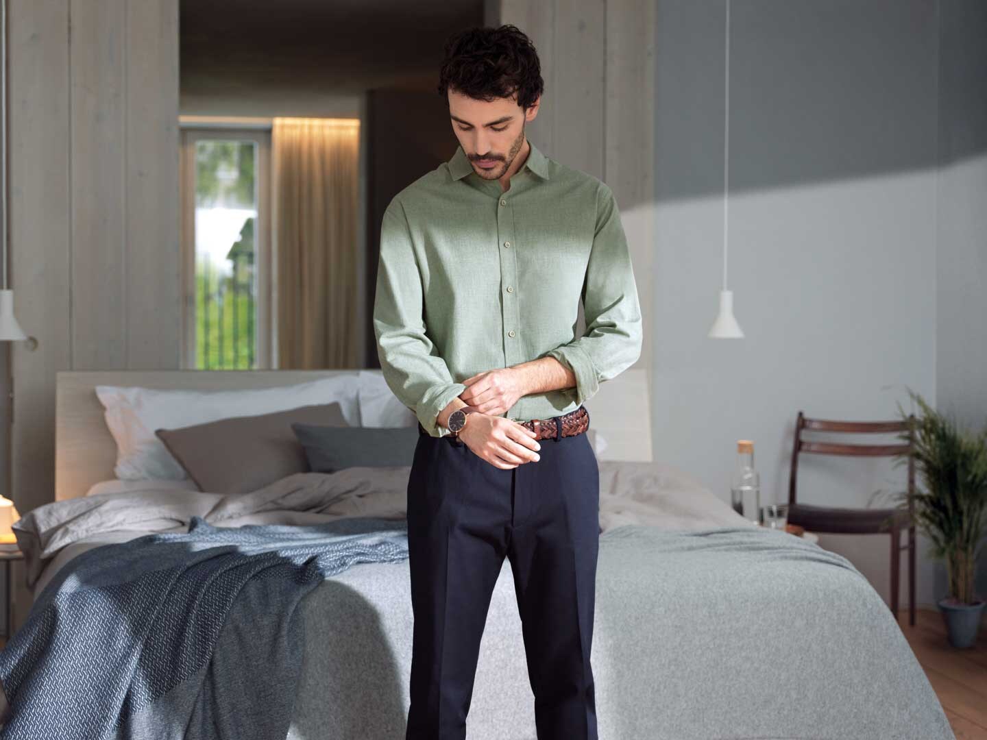 Man in shirt in modern bedroom